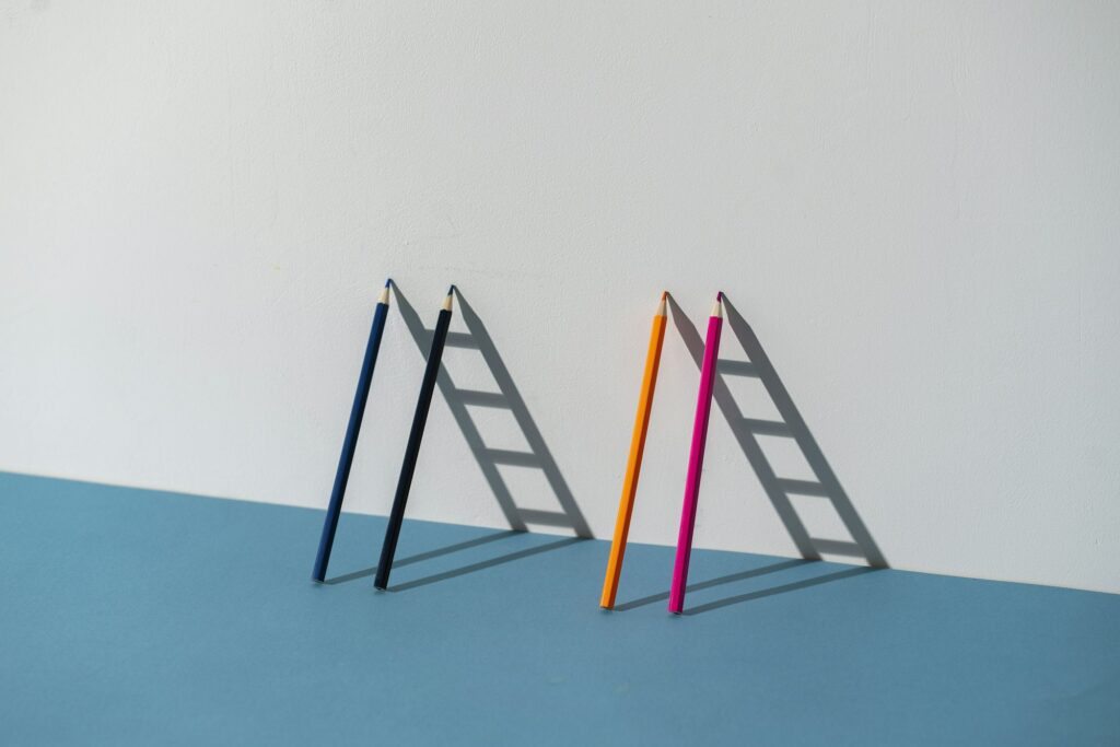 a pencil leaned on the wall and creating ladder made of shadow