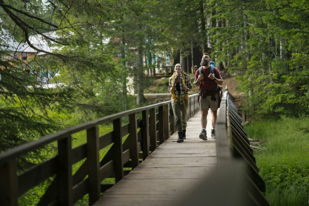 Couple Walking on Wooden Bridge in Forest